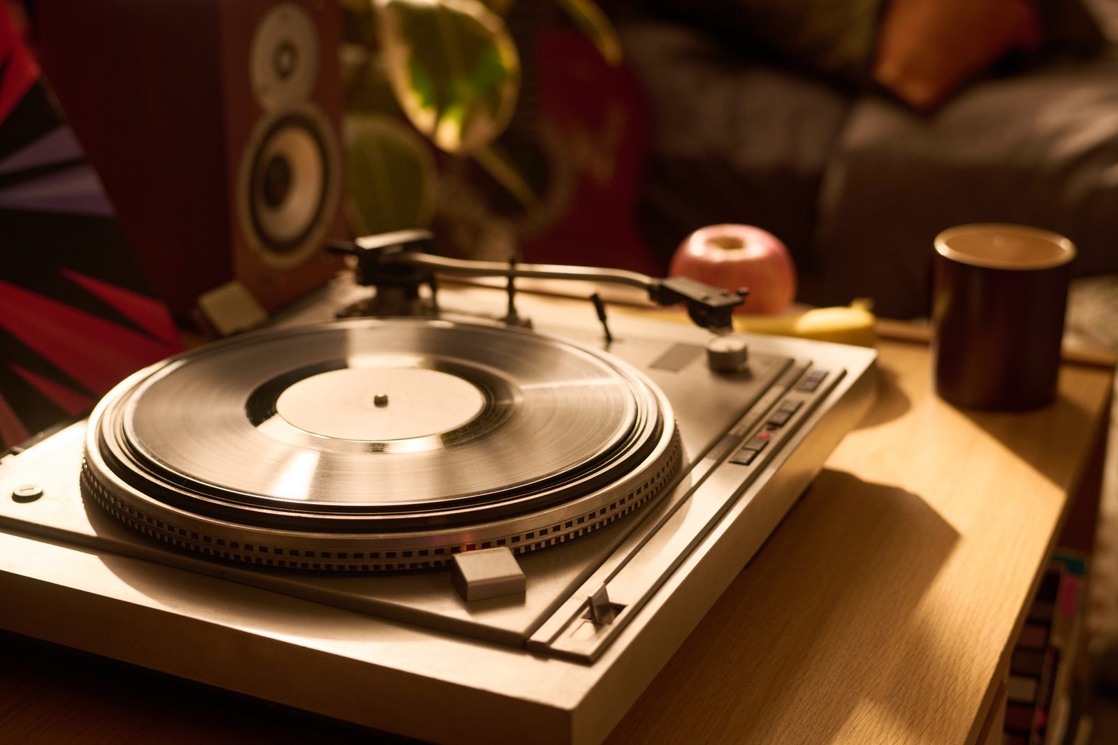 Retro record player spinning a vinyl record at home